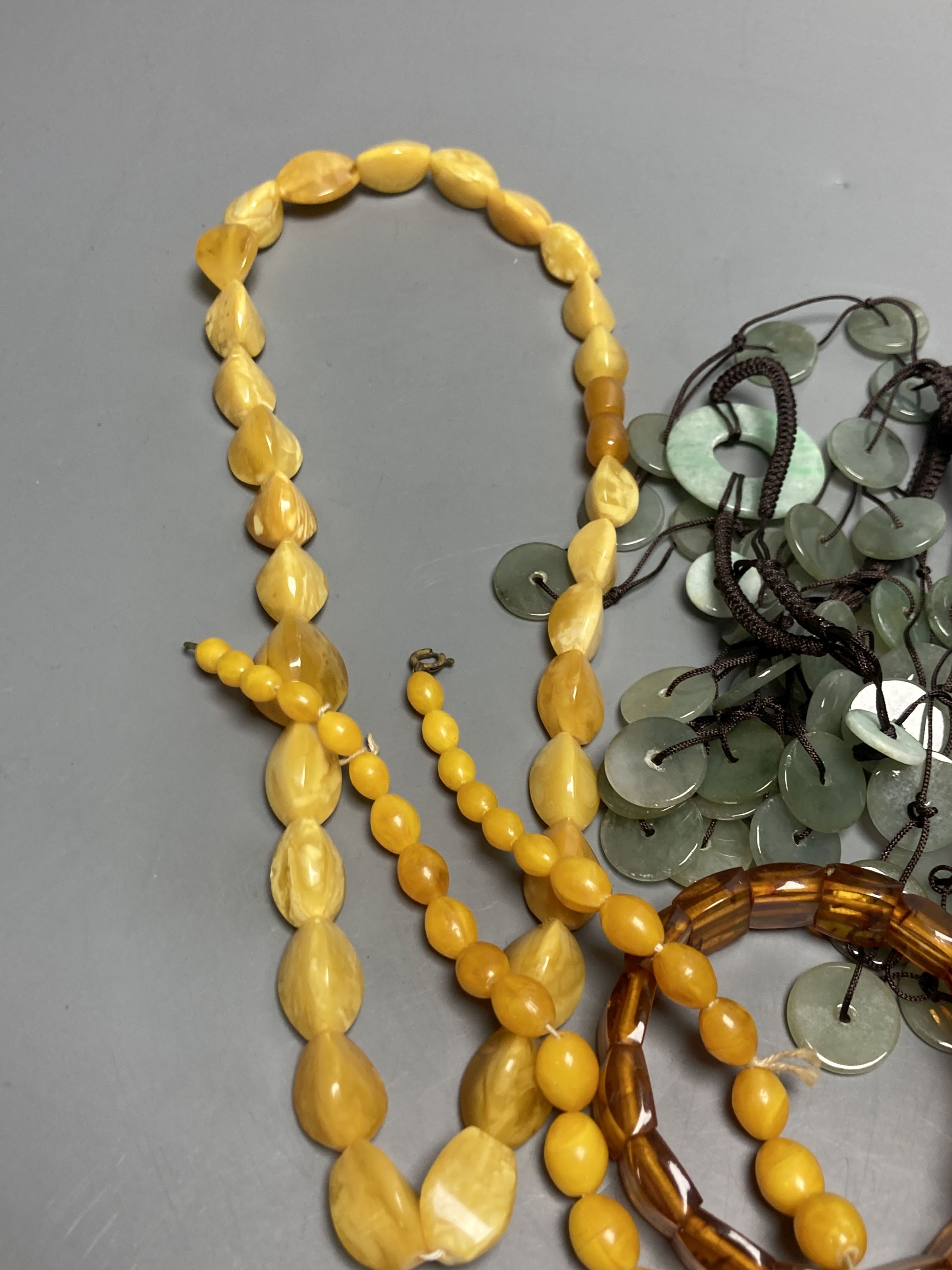 A pale yellow amber bead necklace, 56cm, gross 45 grams and other necklaces including simulated amber.